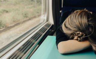 sleeping woman in train at daytime